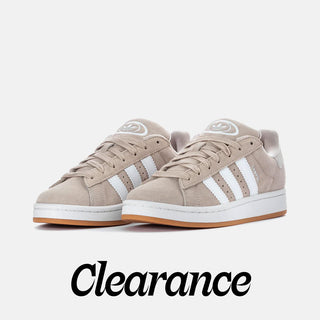 Beige sneakers with white stripes on a light gray background, featuring the word 'Clearance'.