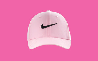 Pink cap with black Nike logo on a pink background